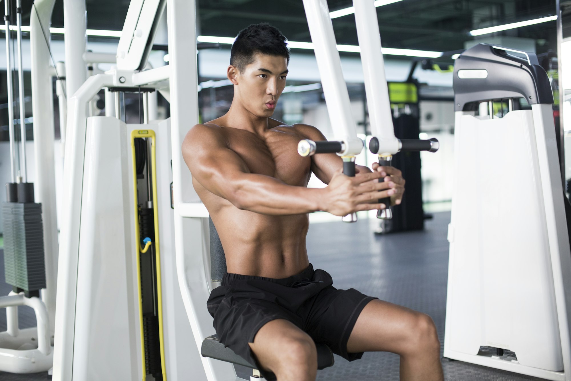 Young man exercising at gym